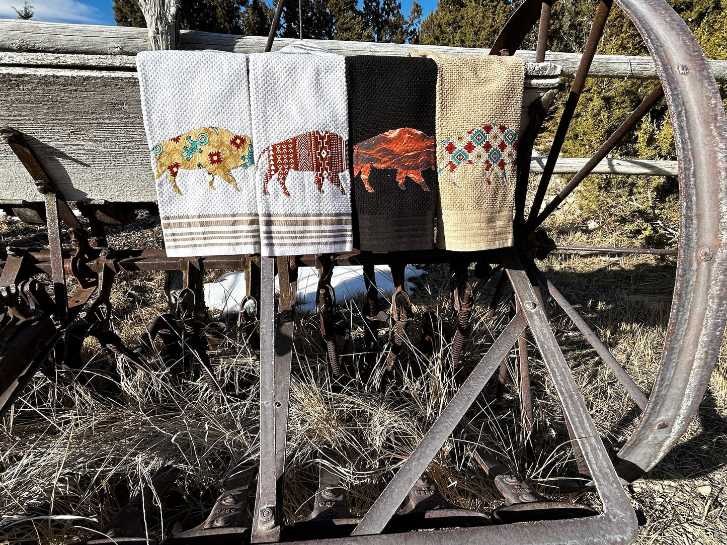 Four Hand Towels, two white , one black and one tan. Each bison is a western pattern and different color