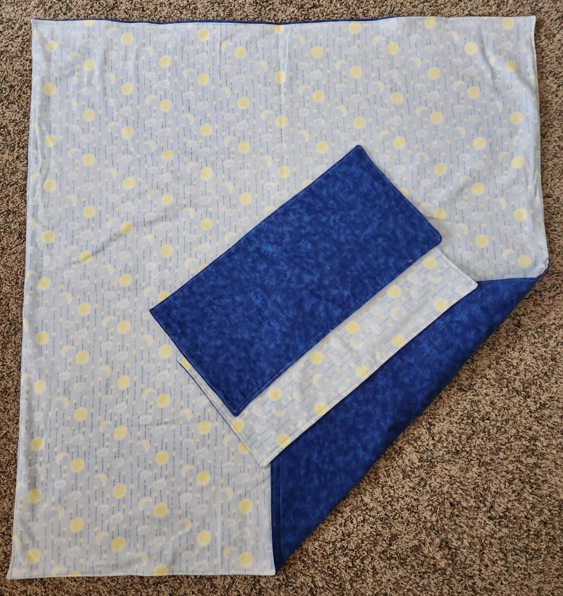 Blue  receiving blanket with two blue burp rags With a Sun and moon pattern