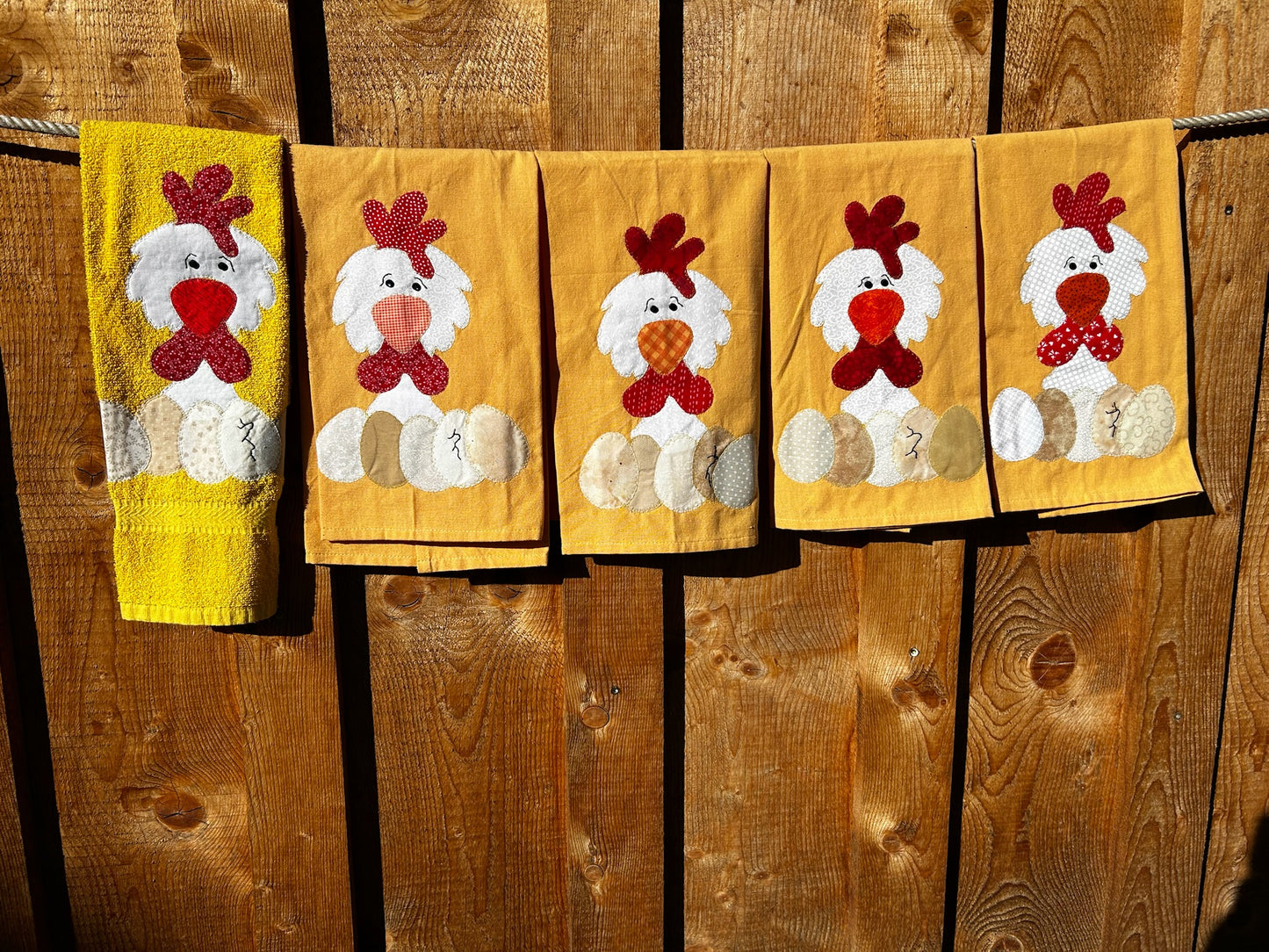 Five Yellow Hand towels all white chickens but there beaks and the four eggs are different colors
