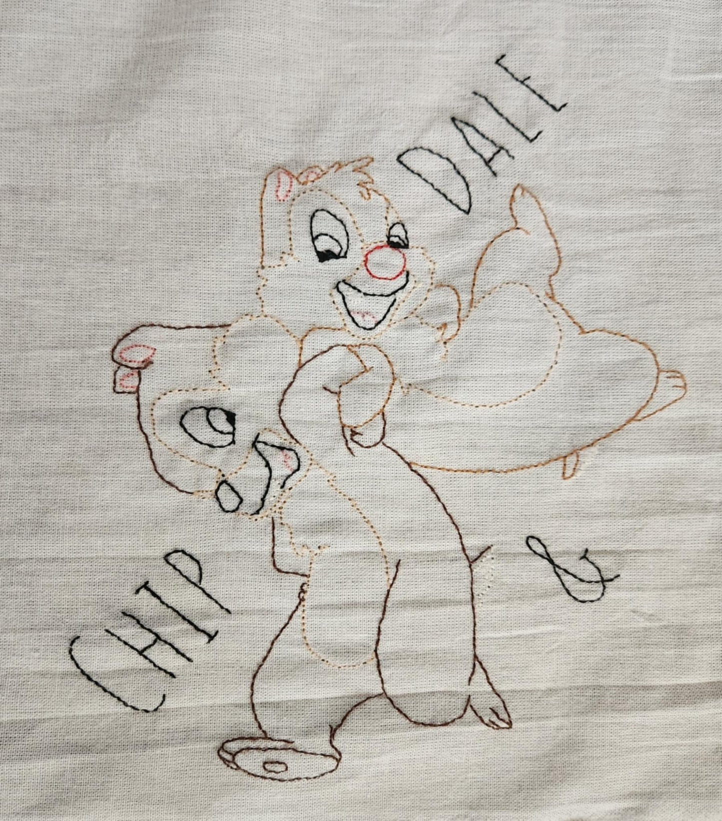 White Dish Towel embroidered Chipmunks Chip and dale arms entwined. The words " Chip And Dale embroidered in black thread on both sides