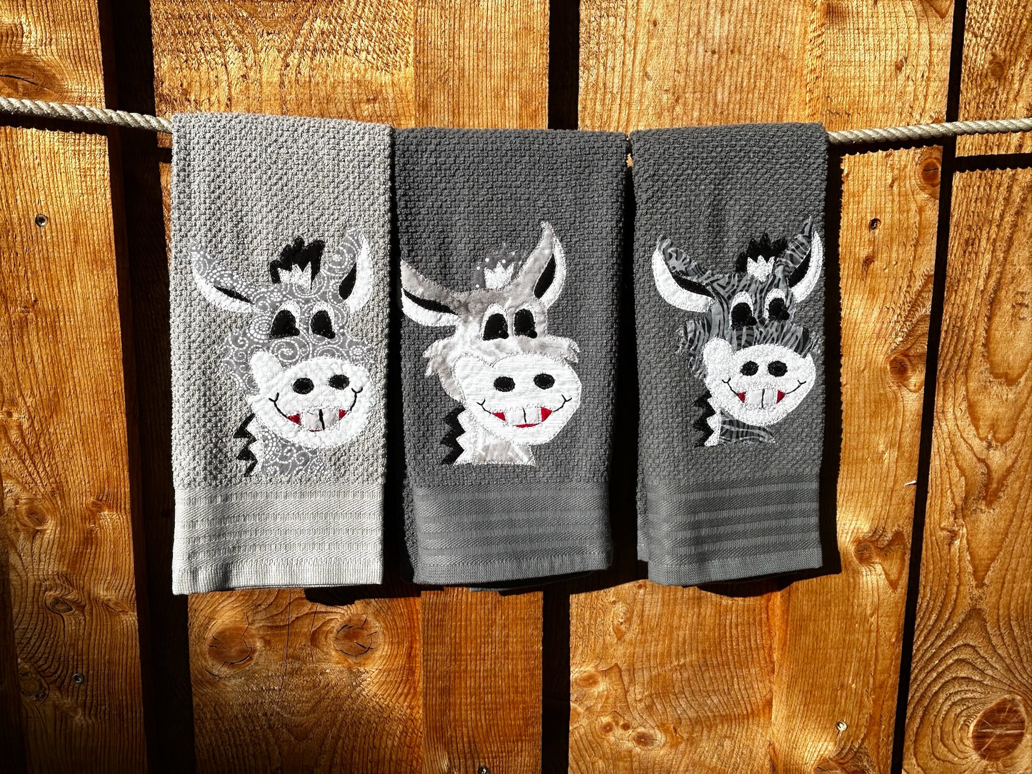Three hand towels is gray. Each Donkey is gray but have different patterns