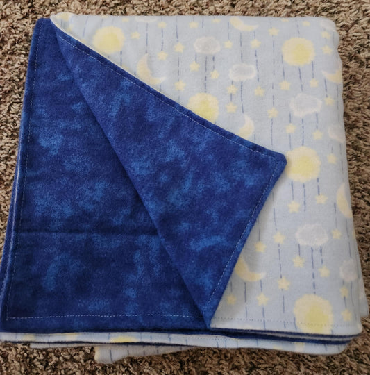 Folded Blue receiving blanket showing dark blue back. With a Sun and moon pattern