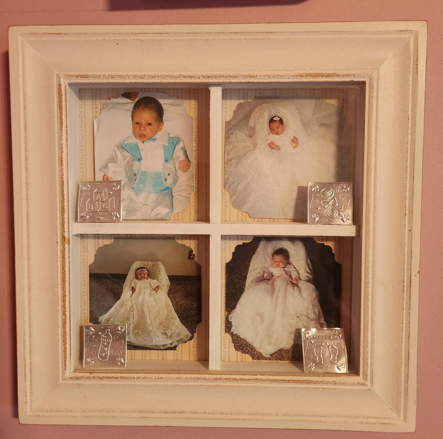 White wood shadow box split into four with a photo of a child in each one