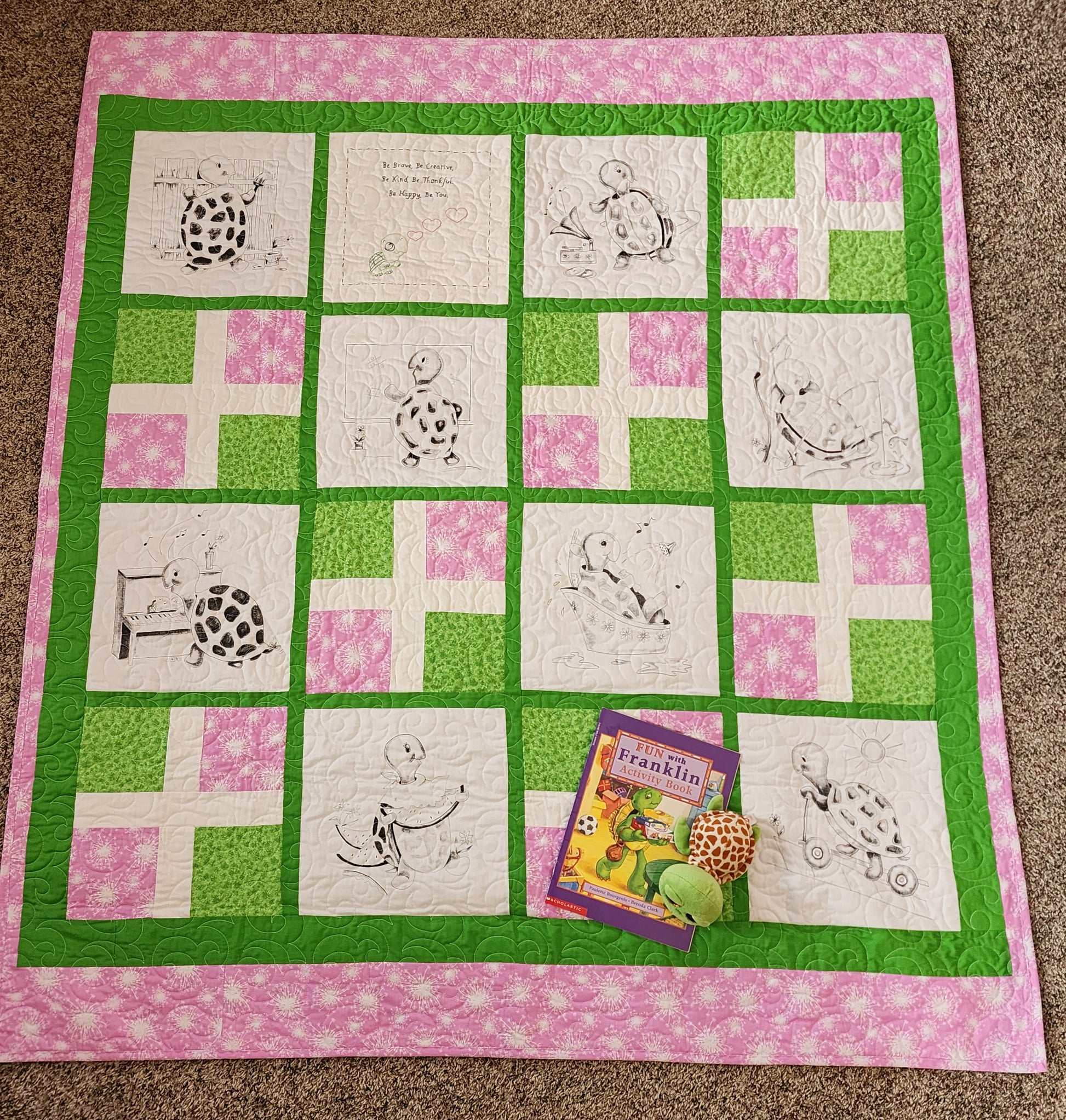 Full Pink and green quilt with turtles doing fun activities. The franklin book and a stuff turtle in the corner