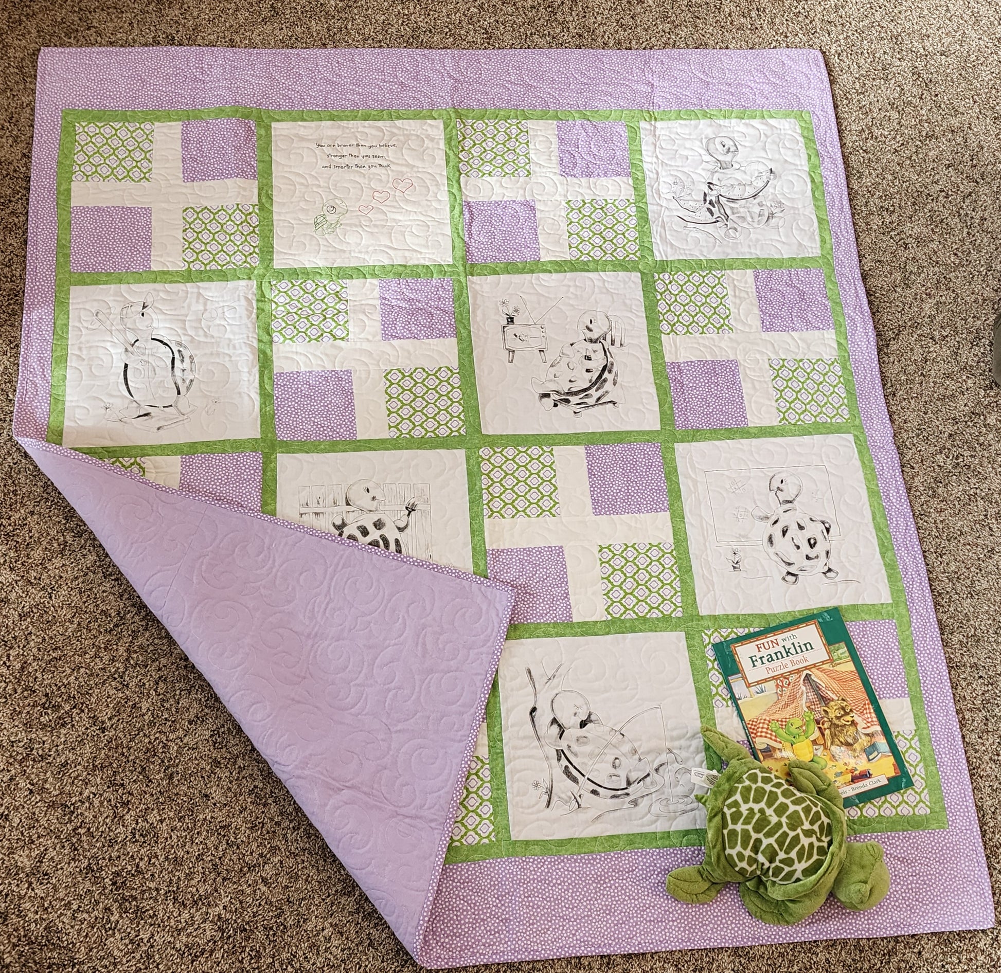 Full Purple and green quilt with turtles doing fun activities with a corner turned up with purple flannel on the back. The franklin book and a stuff turtle in the corner