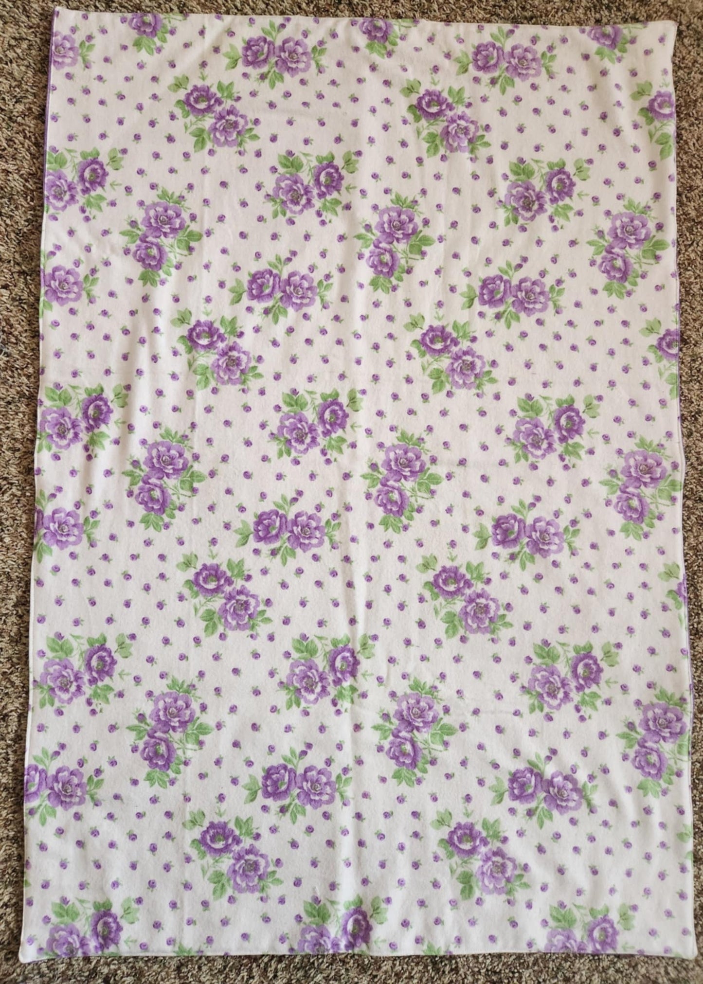 Rectangle Receiving Blanket with purple flowers with green leaves and purple dots with white background.