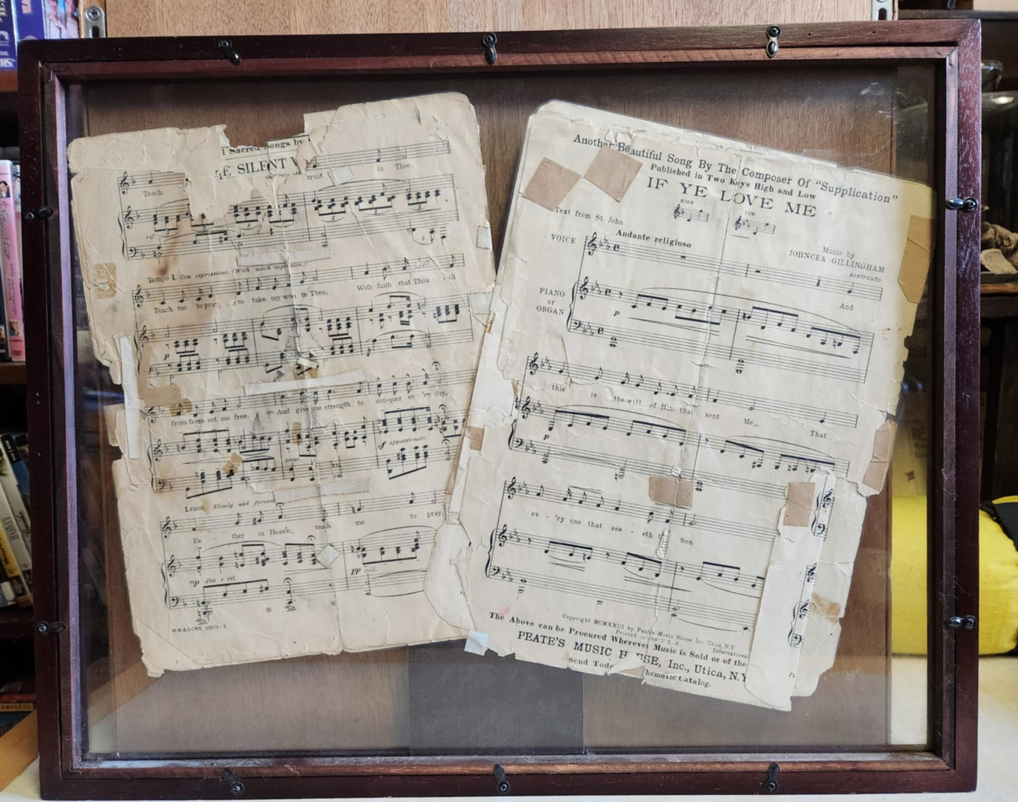 Wood shadow box with two pages of sheet music one silent and the other if ye love me.