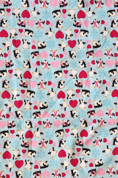 Close up Receiving Blanket with Penguins, red and pink hearts with a blue background Fleece. 