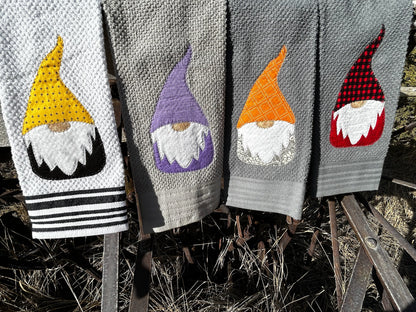 Four dish towels, three gray and one white. Each gnomes have a white beard but there top and bottom is a different color 