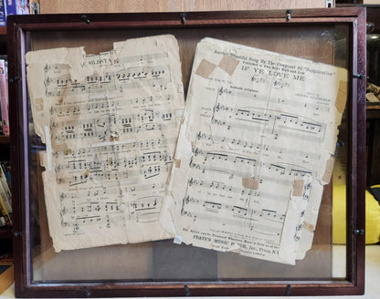 Wood shadow box with two pages of sheet music one silent and the other if ye love me.